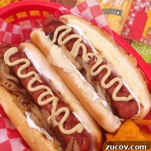 Seattle-Style Hot Dogs: Where to Find the City's Iconic Bite 16 Two Seattle Dogs nestled in a basket with chips