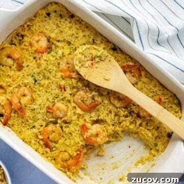 Baked Casserole in white oblong dish with wooden spoon