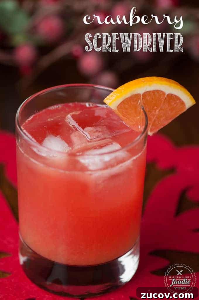 Cranberry Screwdriver with cranberry vodka, orange juice, and a splash of Grand Marnier Cranberry Screwdriver with orange wedge