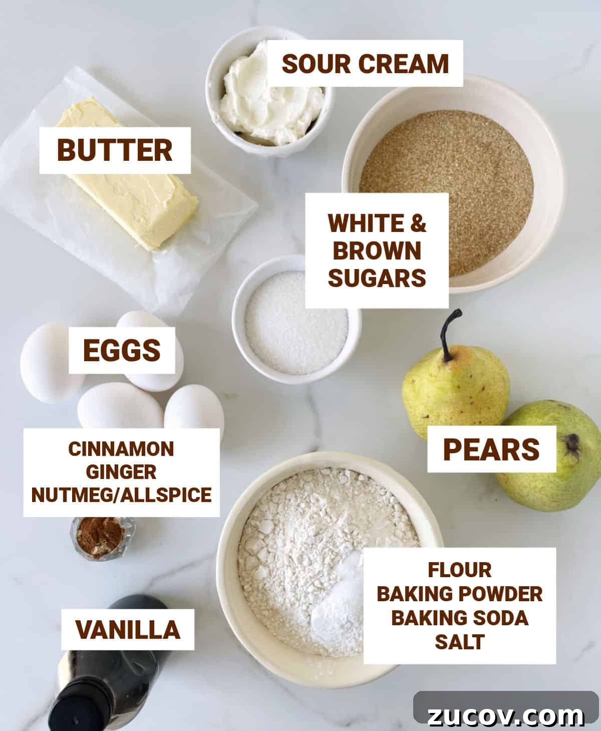 Moist Pear Cake Recipe with Cinnamon Glaze 4 White marble with bowls containing ingredients for pear cake including butter, eggs, sugars, vanilla, spices, flour mixture.