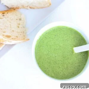 Quick Pistachio Pesto Recipe Ready in 5 Minutes 9 Pesto in a white bowl with a white spoon and a plate of sourdough to the top left of it.