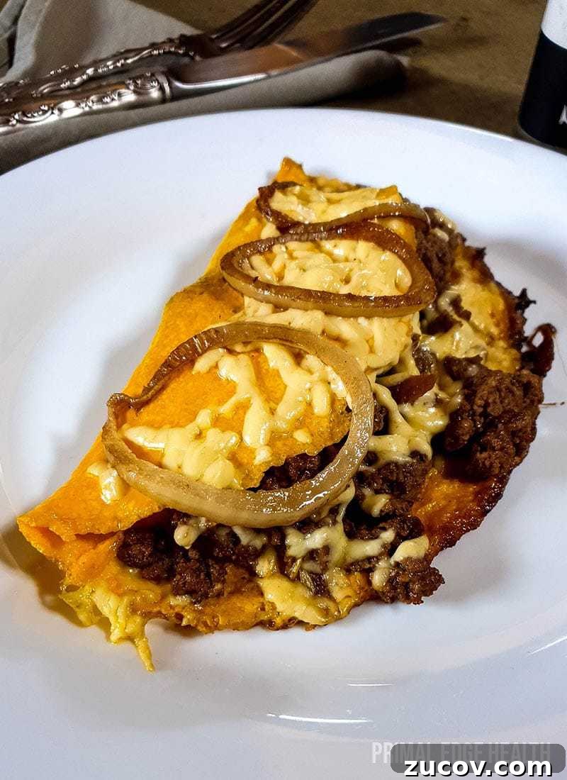 28 Low-Histamine Recipes for Histamine Intolerance-Friendly Meals 13 Omelette with meat on a plate garnished with onions.