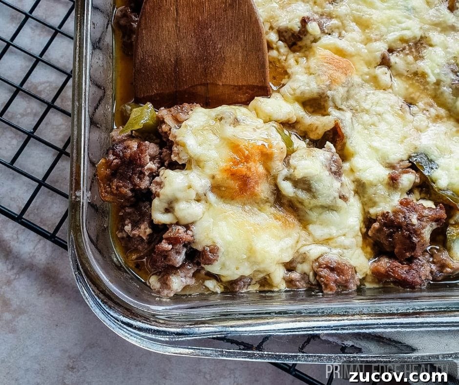 28 Low-Histamine Recipes for Histamine Intolerance-Friendly Meals 17 A glass dish of philly cheesesteak casserole with a wooden spatula.