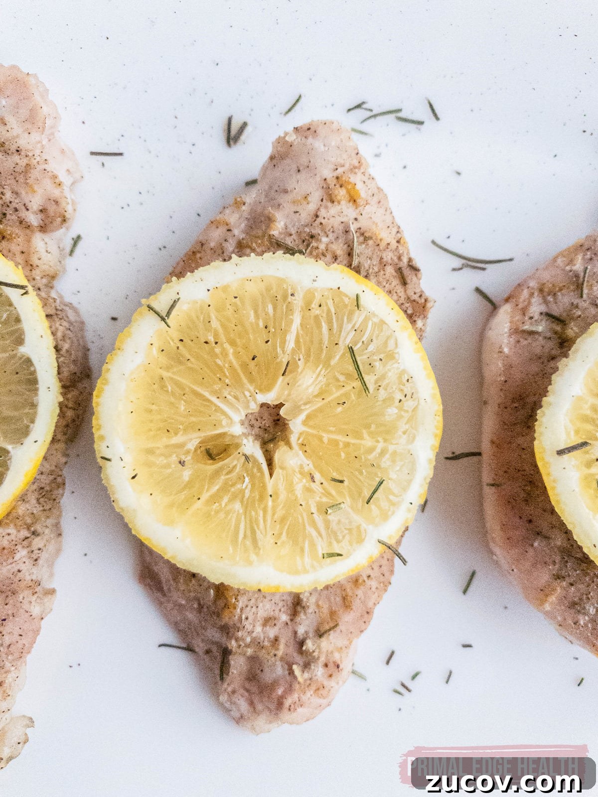28 Low-Histamine Recipes for Histamine Intolerance-Friendly Meals 18 Pork chops seasoned with herbs and lemon slice on top.