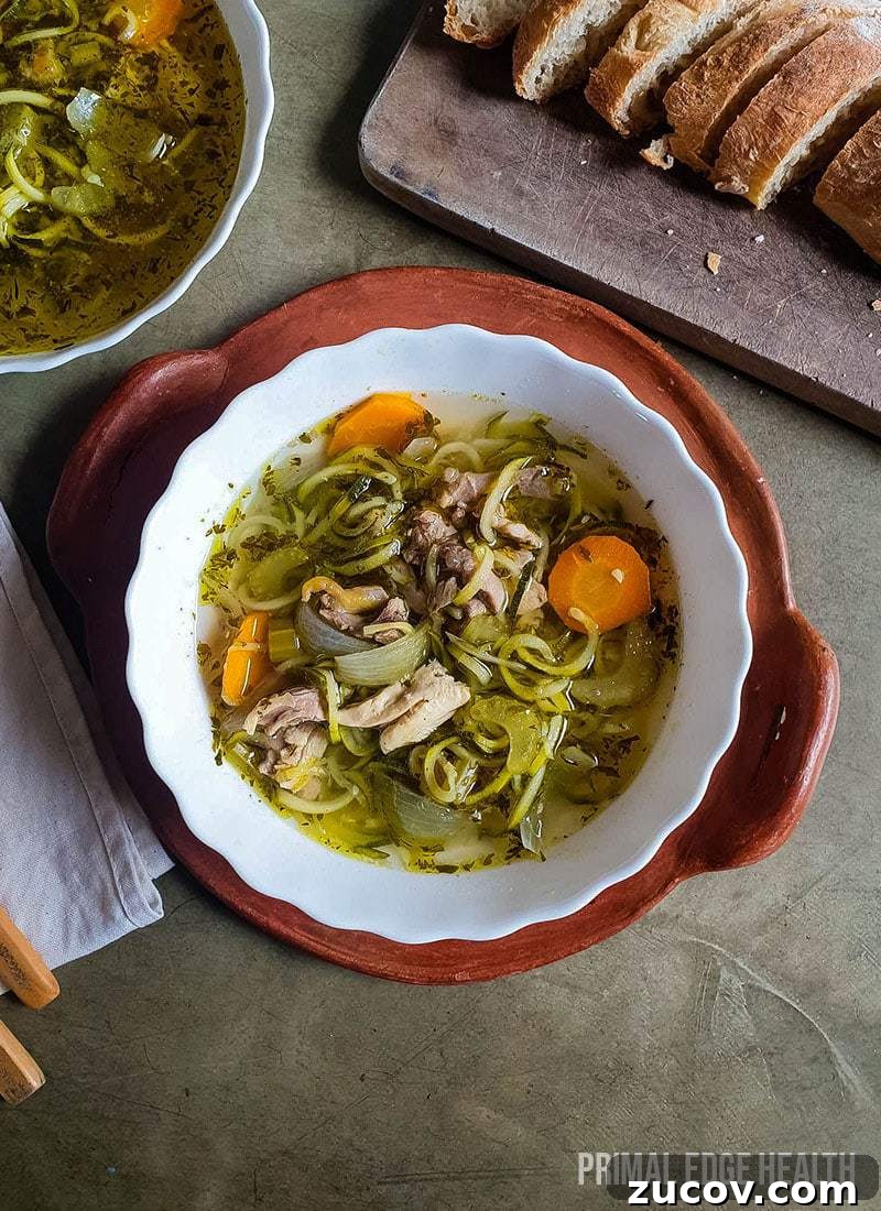 28 Low-Histamine Recipes for Histamine Intolerance-Friendly Meals 20 A bowl of keto chicken noodle soup served with bread on a tray.