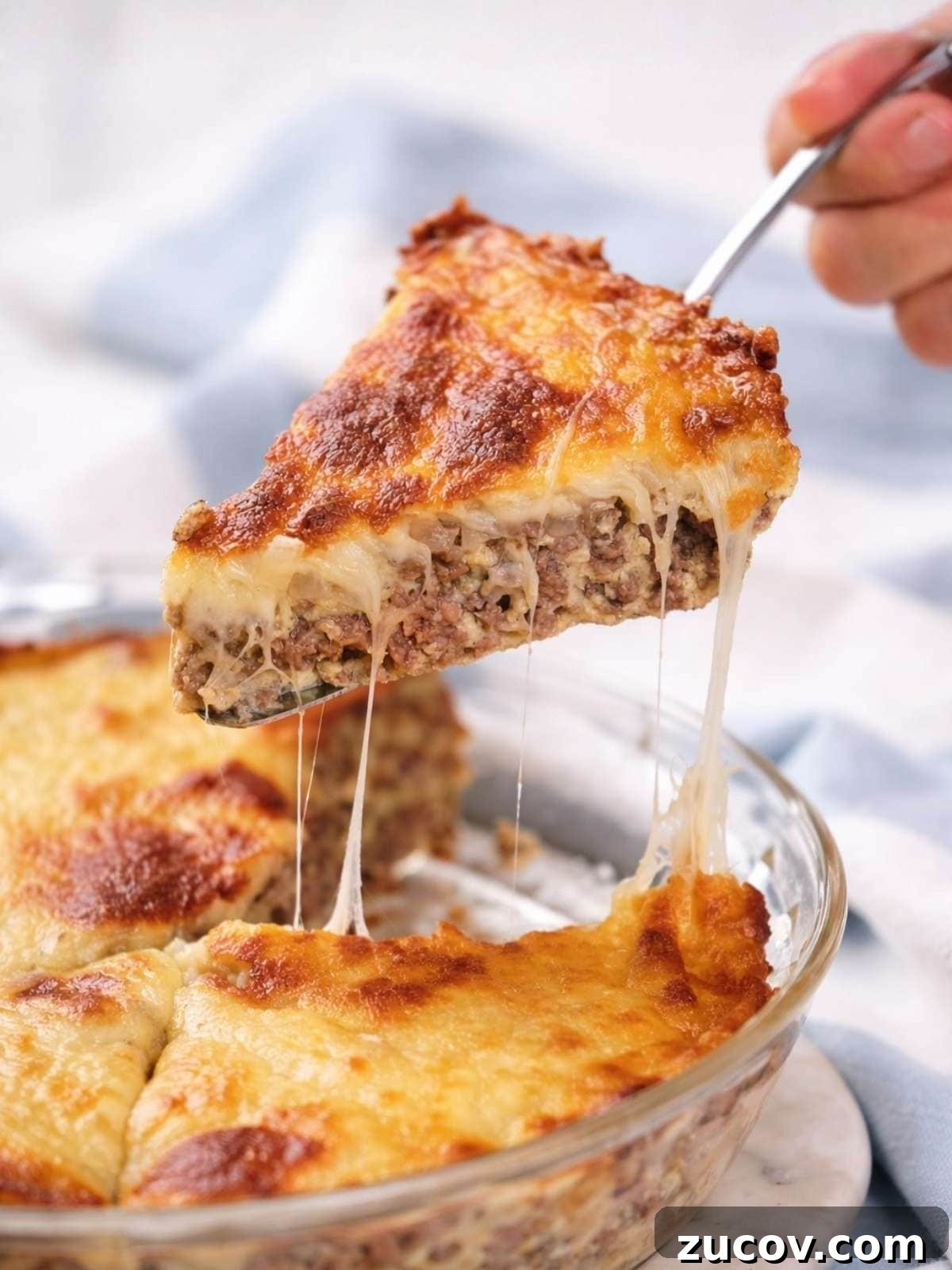 28 Low-Histamine Recipes for Histamine Intolerance-Friendly Meals 8 A slice of easy cheeseburger pie with a browned, melted cheese topping is being lifted from a glass dish, revealing gooey, stretchy cheese.