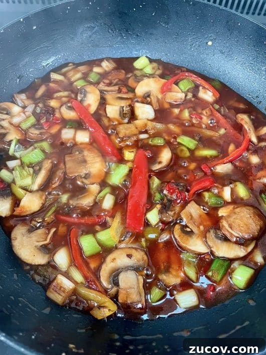 Crispy Chilli Beef Recipe: Crunchy, Spicy Takeout-Style Django 7 Sauce bubbling in pan