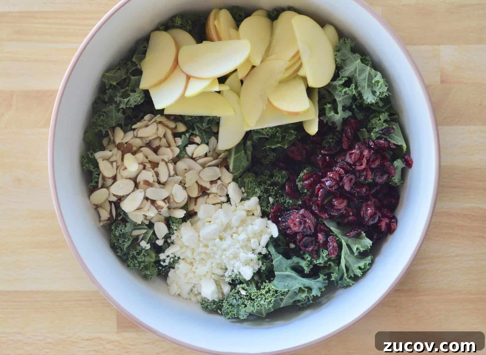 Kale, Cranberry & Feta Salad with Lemon Vinaigrette 4 bowl of ingredients, ready for dressing.