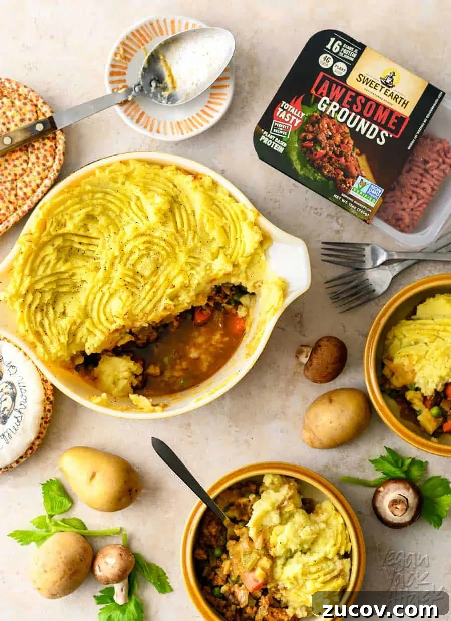 Savory Vegan Shepherd’s Pie with a Flavorful Twist 10 One casserole dish filled with a vegan shepherd's pie, spooned into two bowls, with potatoes and mushrooms scattered around them, on a light linoleum background. There is also a container of Sweet Earth Foods Awesome Grounds in the upper right corner.