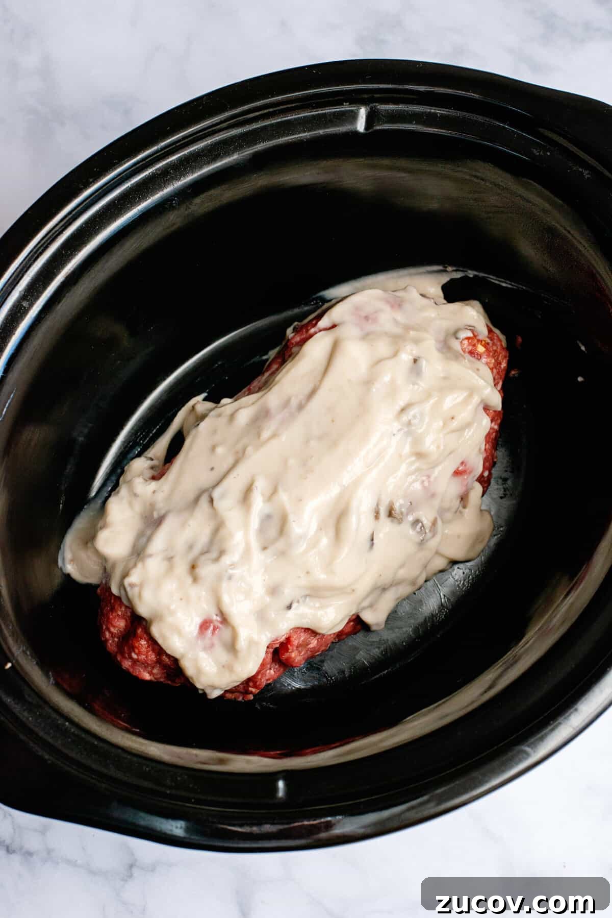 Classic Slow Cooker Meatloaf Recipe for Tender, Juicy Results 7 pour cream of mushroom soup over the loaf