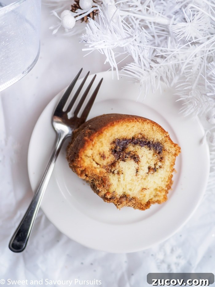 Decadent Chocolate Cinnamon Bundt Cake Recipe 5 Slice of Cinnamon Swirl Cake on small white plate.