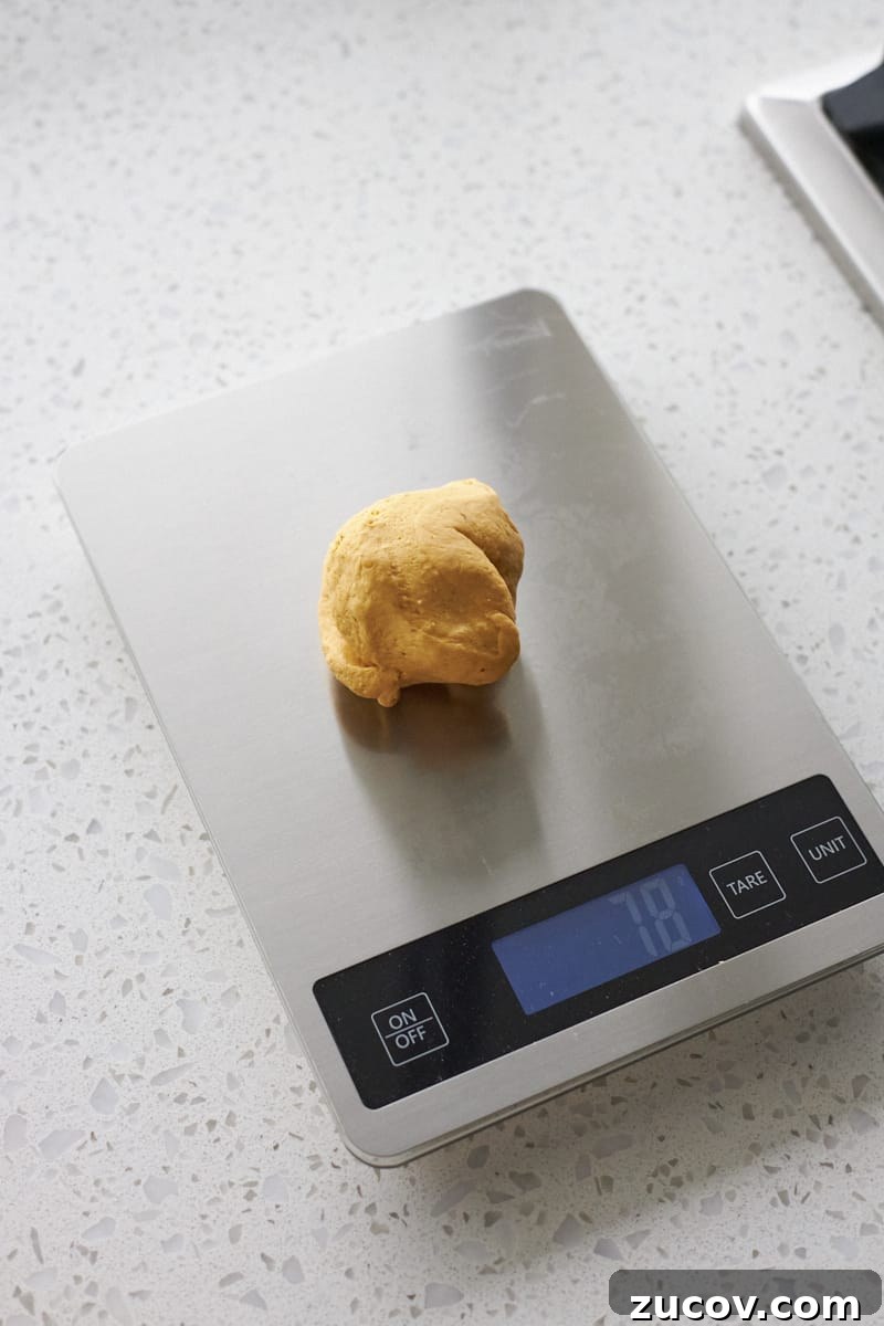 Sourdough-Discard Pumpkin Dinner Rolls for Fall Baking 7 Dough on a scale.