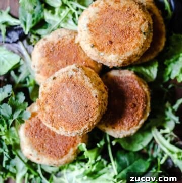 Gluten-Free Salmon Fishcakes Recipe: Crispy, Flavorful, Quick 6 Salmon fishcakes on a bed of leaves