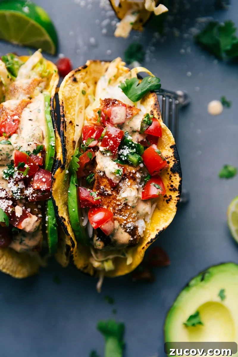 Fish Tacos - A Flavorful Delight Two fish tacos stuffed with delicious toppings, ready to be savored.