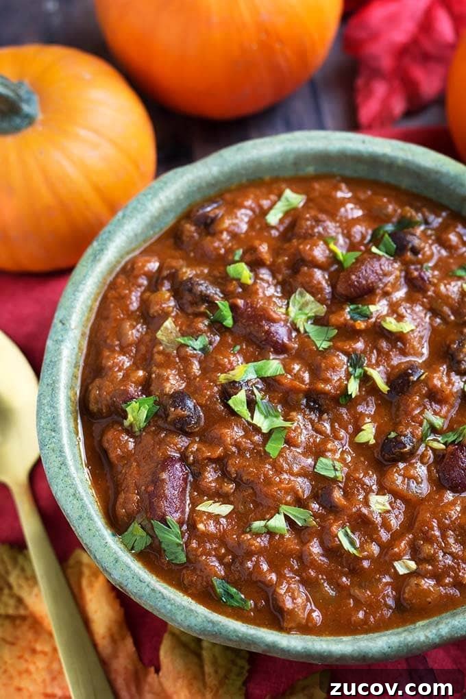 Instant Pot Pumpkin Chili Recipe for Cozy Weeknight Dinners 3 Pumpkin Chili in a turquoise bowl in front of two small pumpkins