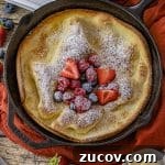 Cast-Iron Dutch Baby Pancake Recipe for a Crispy, Fluffy Oven Skillet 7 puffy dutch baby pancake in a cast iron skillet