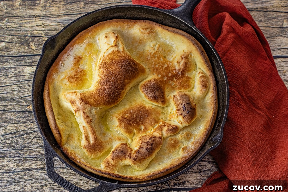 Cast-Iron Dutch Baby Pancake Recipe for a Crispy, Fluffy Oven Skillet 3 puffy dutch oven pancake in a cast iron skillet