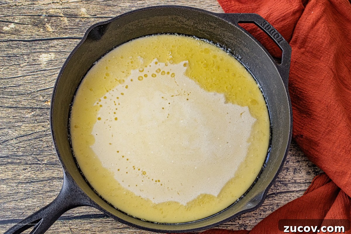 Cast-Iron Dutch Baby Pancake Recipe for a Crispy, Fluffy Oven Skillet 4 uncooked dutch baby pancake in a cast iron skillet