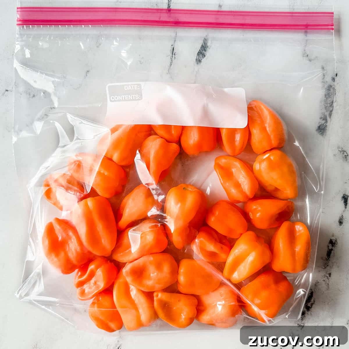 Freeze Habanero Peppers: Simple Steps to Preserve Heat and Flavor 8 Frozen habanero peppers are shown in a freezer-safe plastic bag.