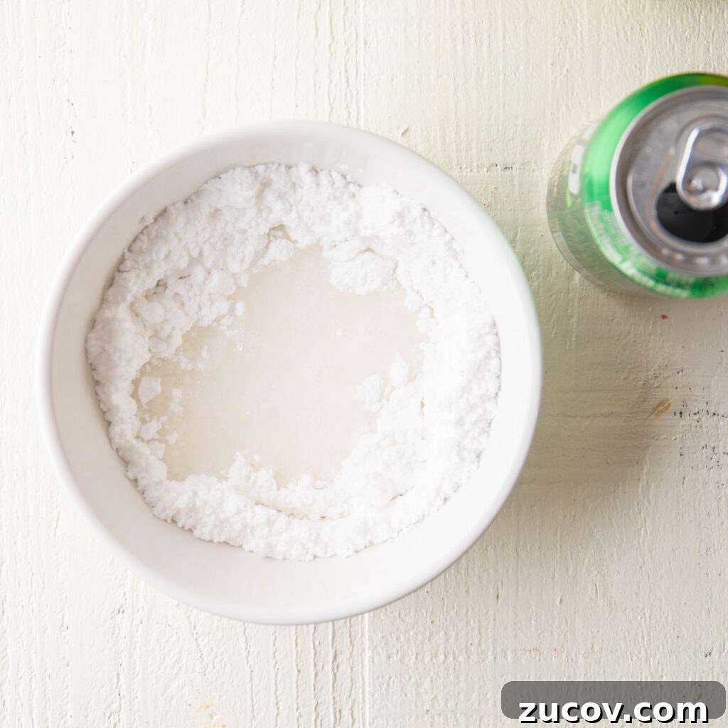 7-Up Pound Cake Recipe: Classic Southern Soul Food Treat 17 7-up soda and confectioners sugar in a small white mixing bowl