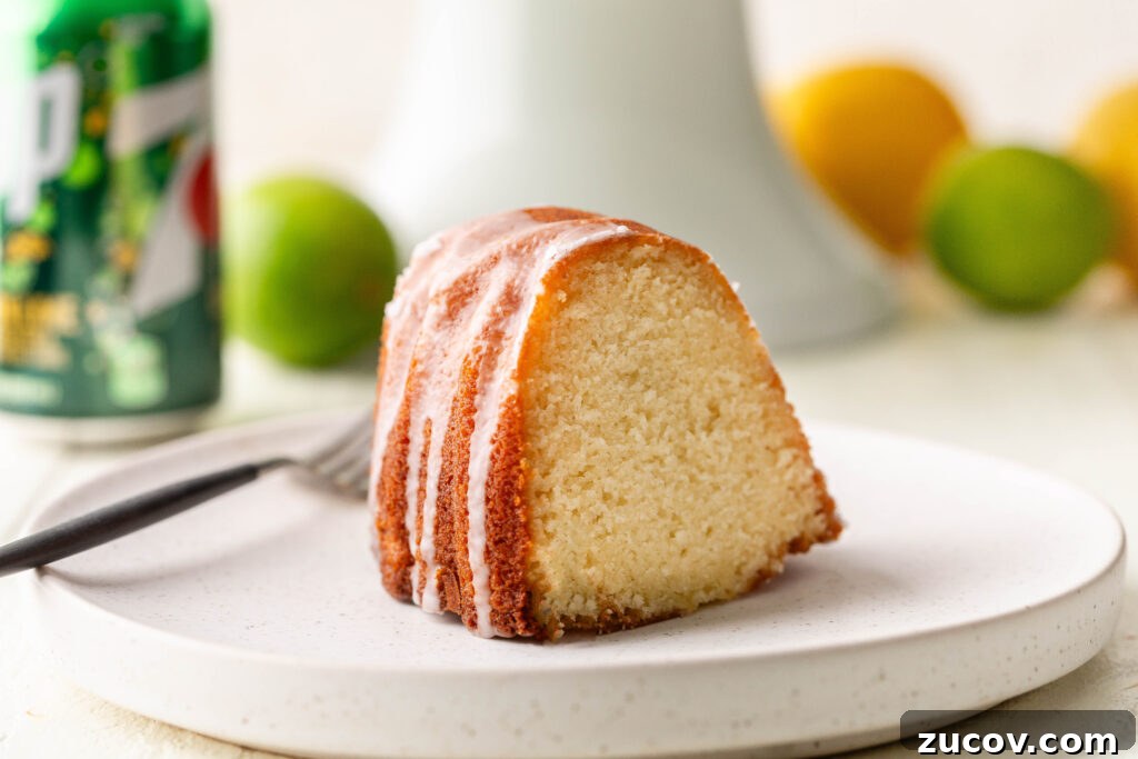 7-Up Pound Cake Recipe: Classic Southern Soul Food Treat 19 slice of 7 up pound cake on white serving plate with can of 7 up, lemons and limes in the background