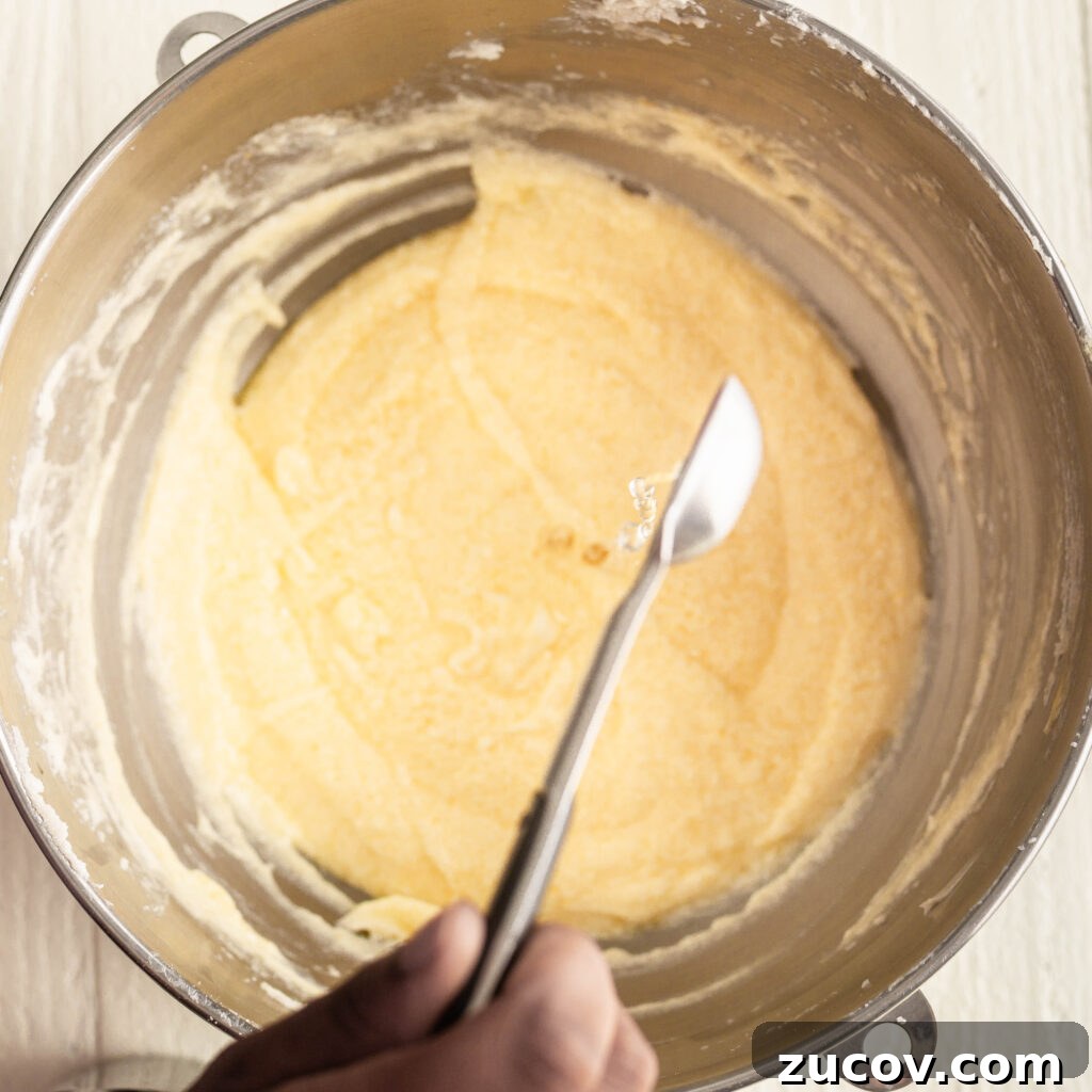 7-Up Pound Cake Recipe: Classic Southern Soul Food Treat 10 pouring lemon extract into butter and sugar mixture