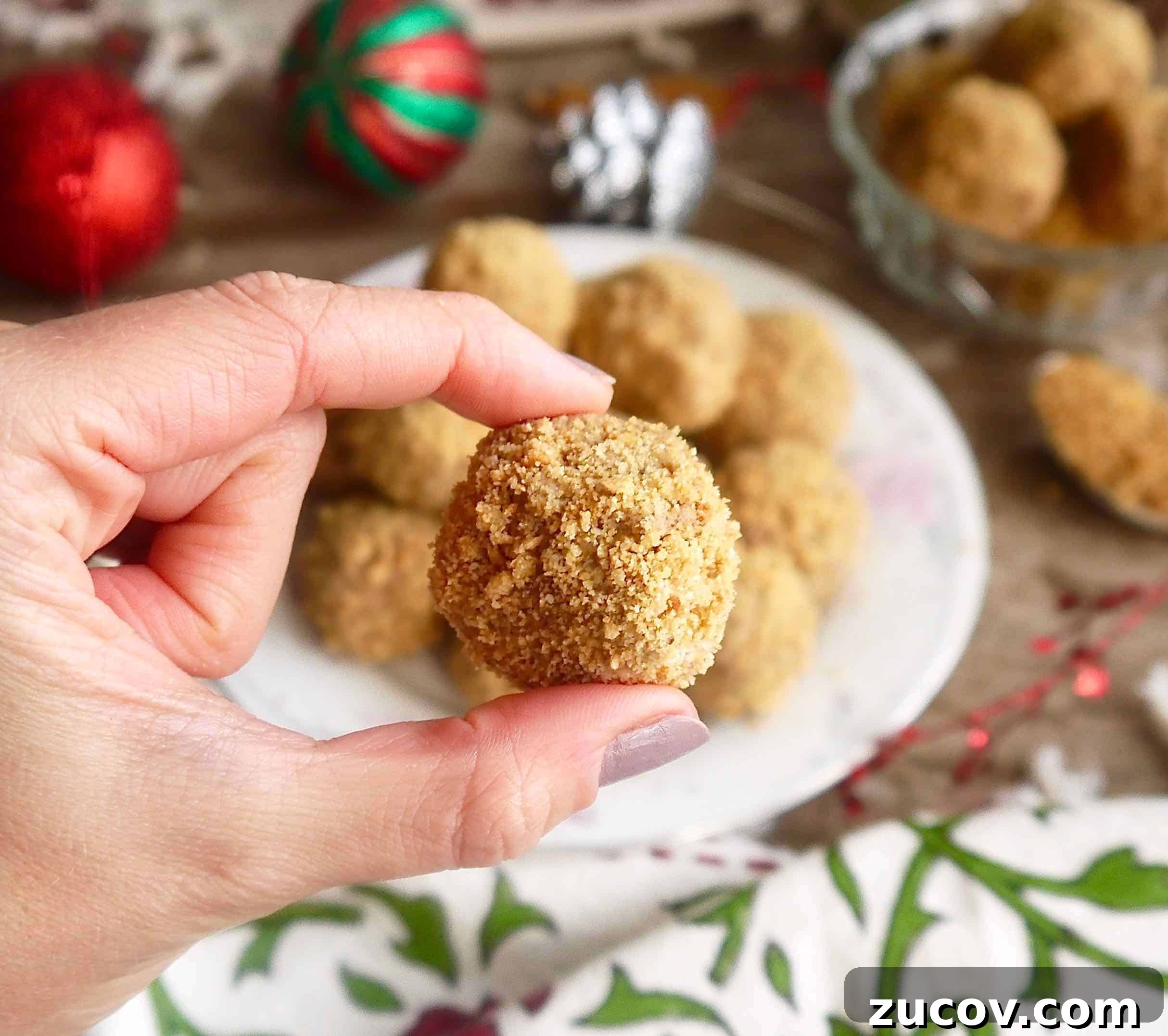 Paleo Chocolate Mousse Truffles Recipe for Decadent Snack 2 A paleo chocolate mousse truffle in someone's hands.