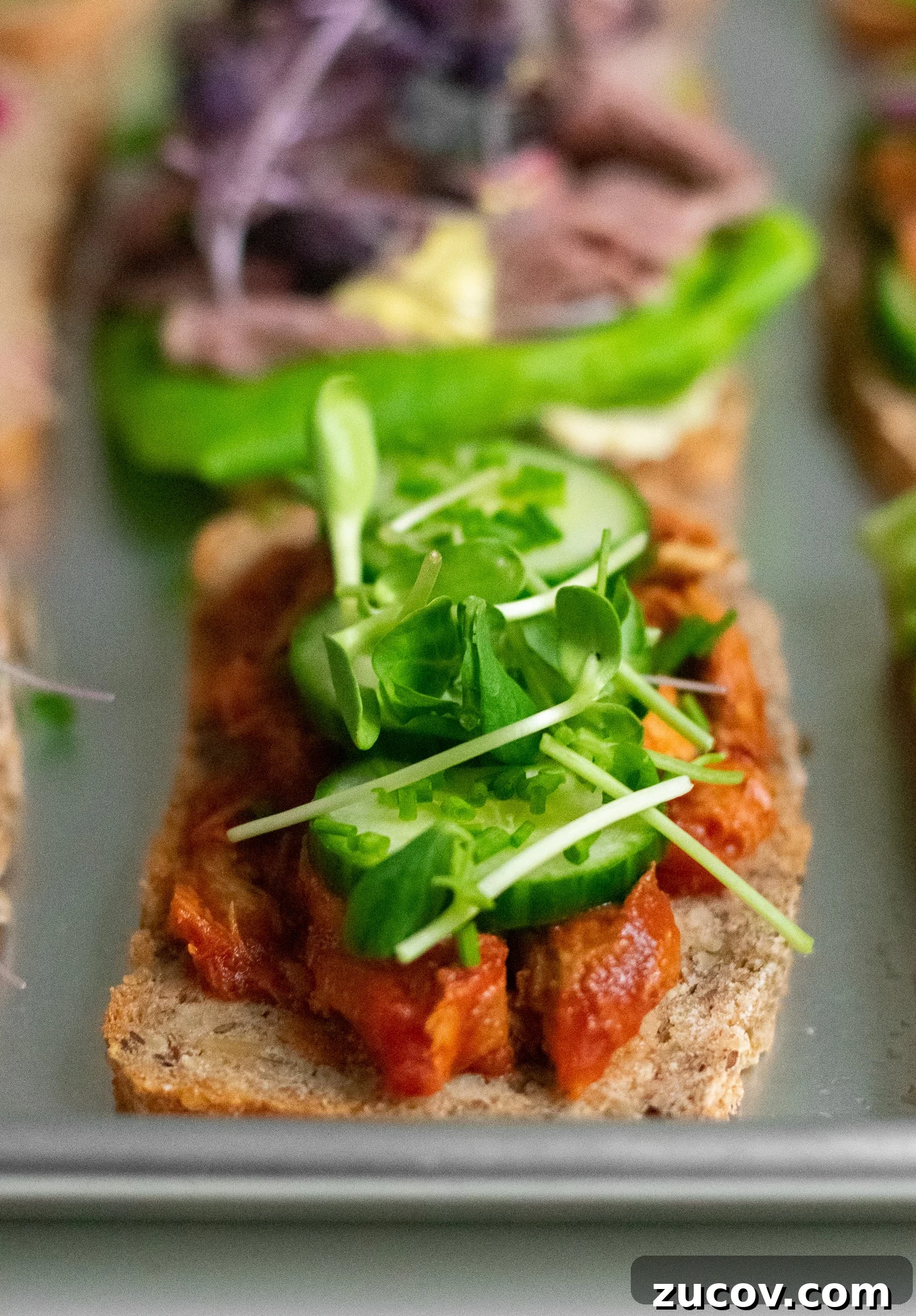 How a Sandwich Became Denmark’s Iconic Smørrebrød: Complete Guide 2 A rye bread open faced sandwich topped with mackerel in tomato sauce, cucumber, chives, and micro greens.