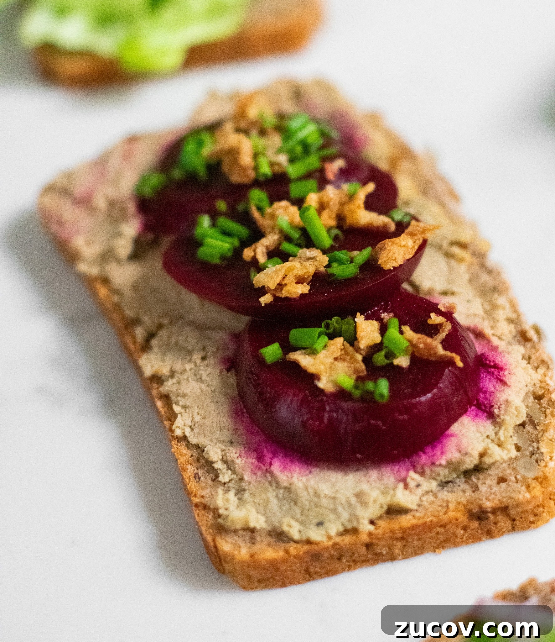 How a Sandwich Became Denmark’s Iconic Smørrebrød: Complete Guide 20 A rye bread open faced sandwich topped with liver pate, pickled beets, and fried onions.