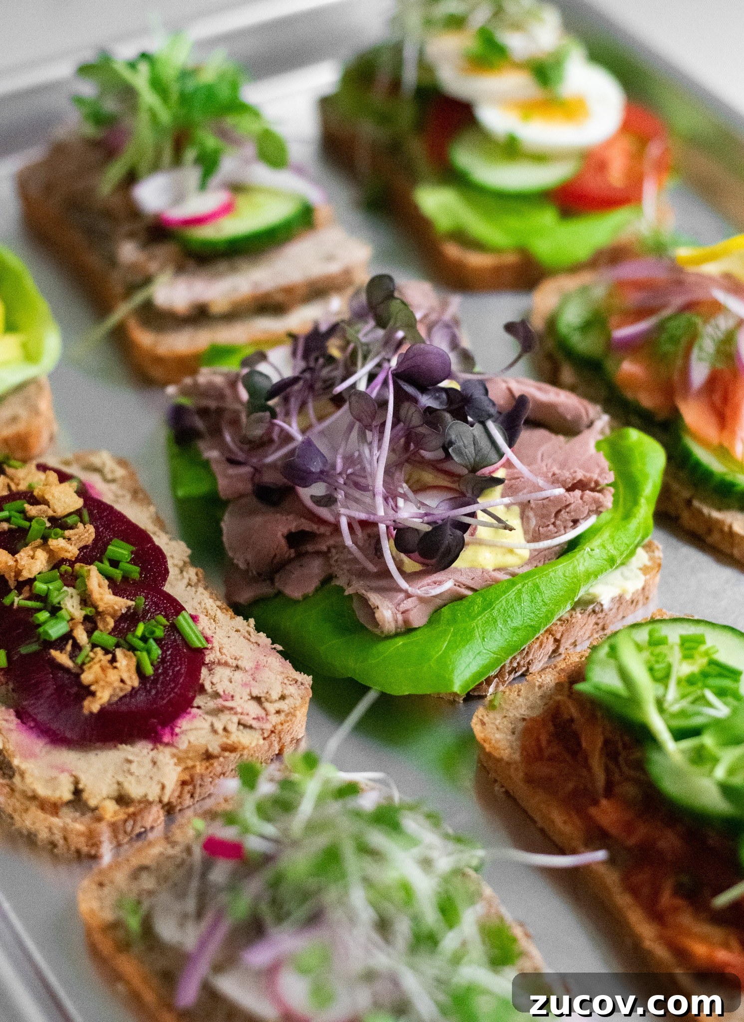 How a Sandwich Became Denmark’s Iconic Smørrebrød: Complete Guide 3 Danish open faced sandwiches on a platter.
