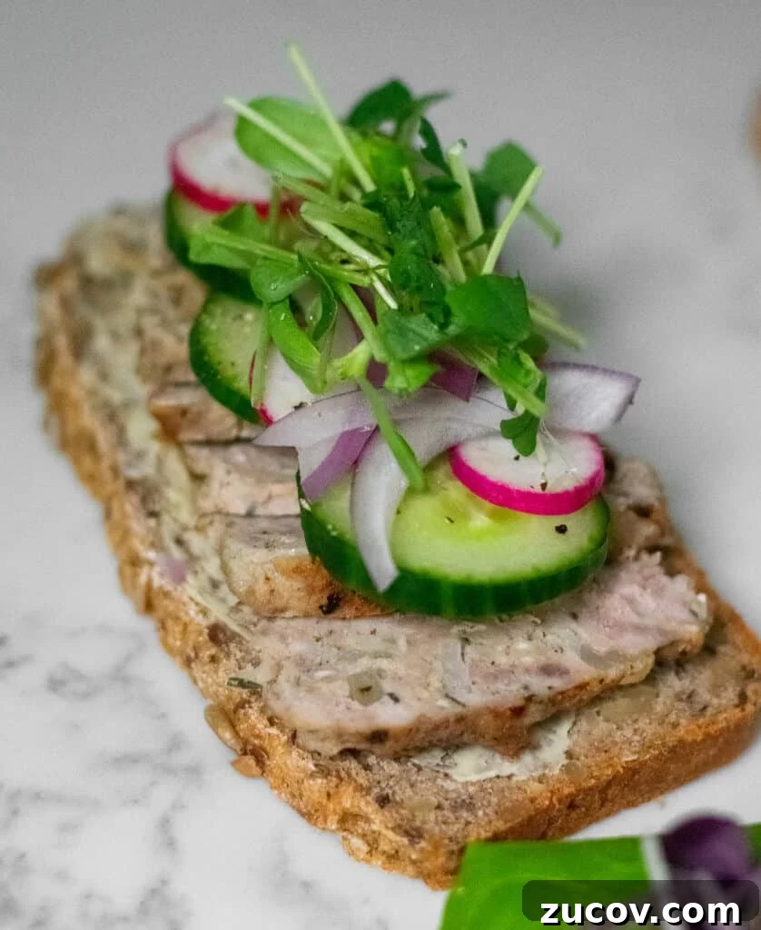 How a Sandwich Became Denmark’s Iconic Smørrebrød: Complete Guide 25 A rye bread open faced sandwich topped with danish meatballs, cucumber, radish, onion, and micro greens.