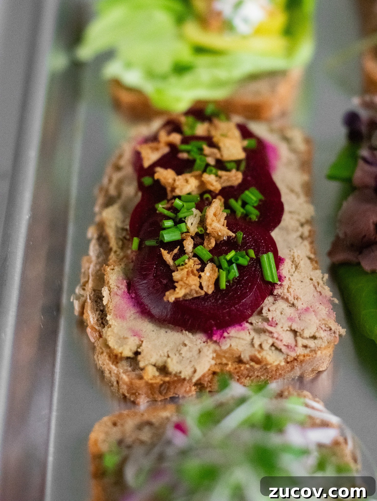 How a Sandwich Became Denmark’s Iconic Smørrebrød: Complete Guide 8 A rye bread open faced sandwich topped with liver pate, pickled beets, and fried onions.