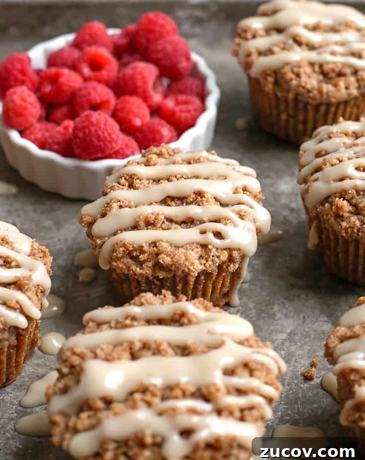 Paleo Coffee Cake Muffins Recipe — Gluten-Free Morning Treat 5 paleo coffee cake muffins on a tray with raspberries