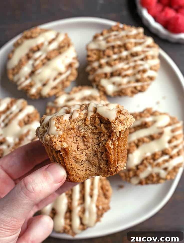 Paleo Coffee Cake Muffins Recipe — Gluten-Free Morning Treat 8 paleo coffee cake muffins, one in a hand with a bite taken out of it