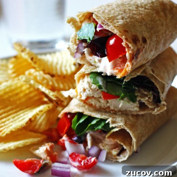 Smoky BBQ Chicken Quesadillas with Melty Cheese and Cilantro 8 Three chicken bacon ranch wraps stacked on a plate with chips.