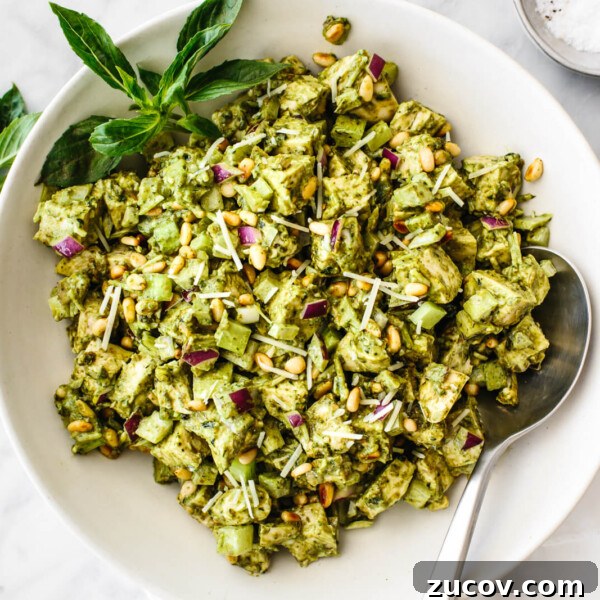 A white bowl of pesto chicken salad
