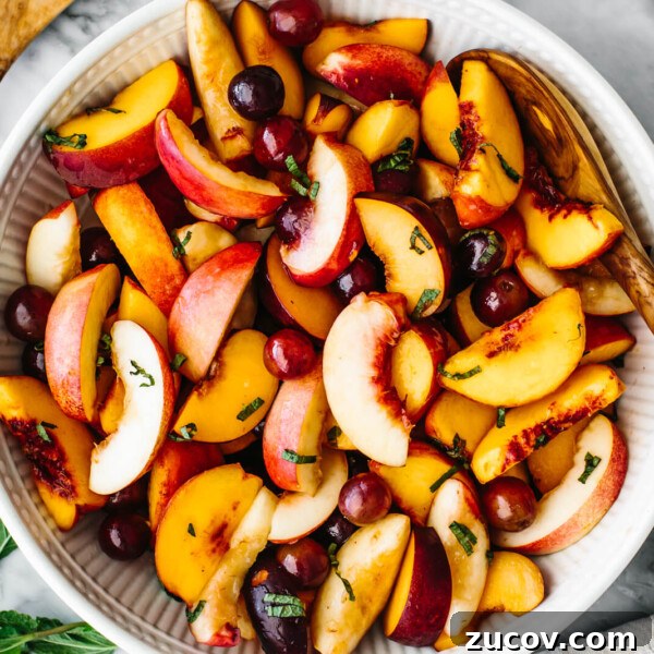 A large white bowl of stone fruit salad