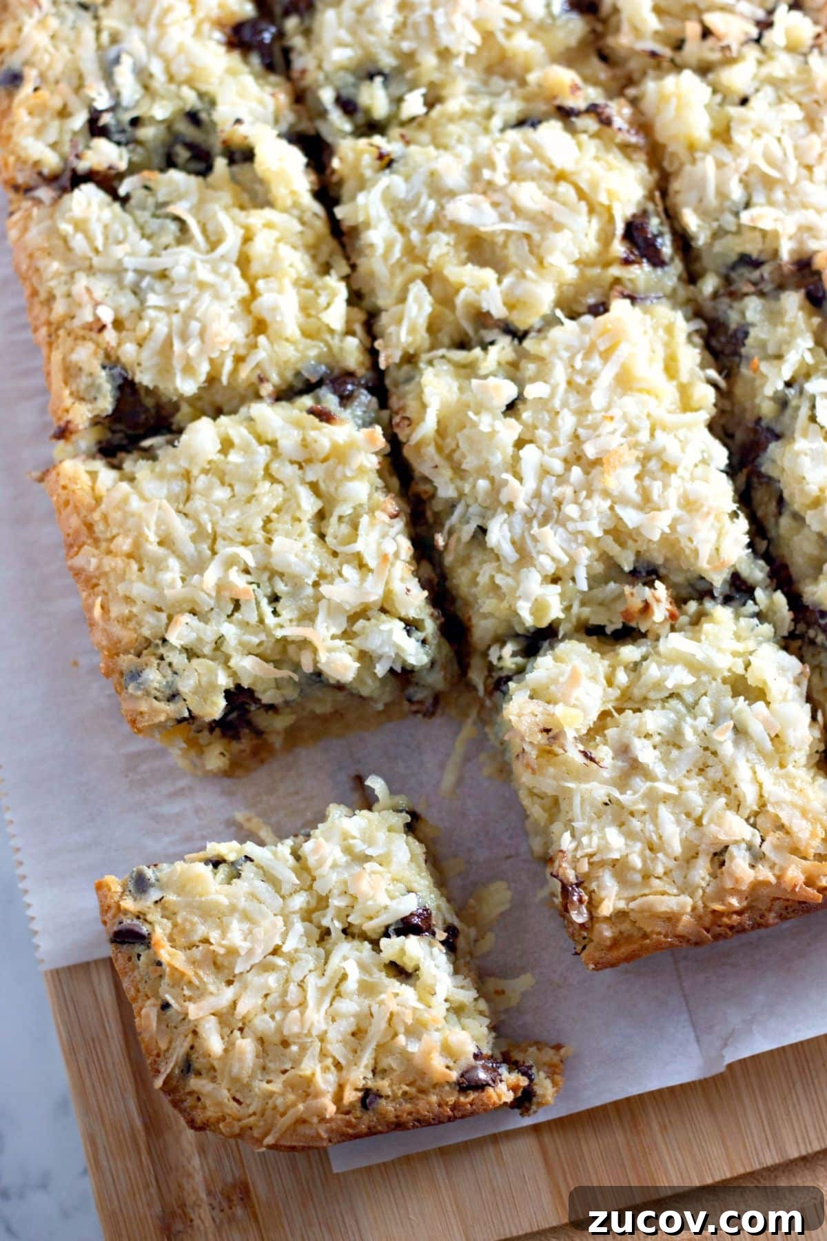 Coconut Butter Bars Recipe with Creamy Coconut Filling 3 Coconut butter bars being cut on a counter.