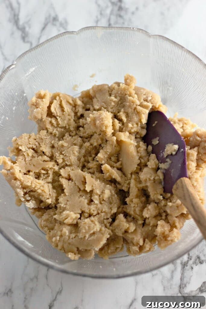 Coconut Butter Bars Recipe with Creamy Coconut Filling 4 Crust being mixed in a large bowl.