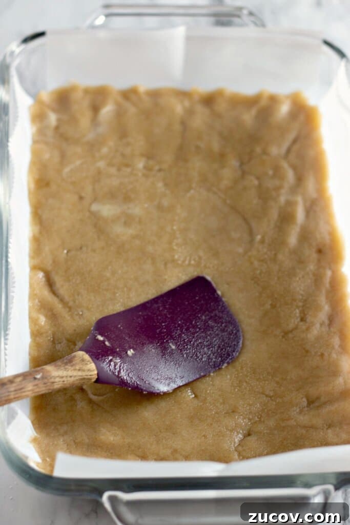 Coconut Butter Bars Recipe with Creamy Coconut Filling 6 Crust being pressed into a baking dish.