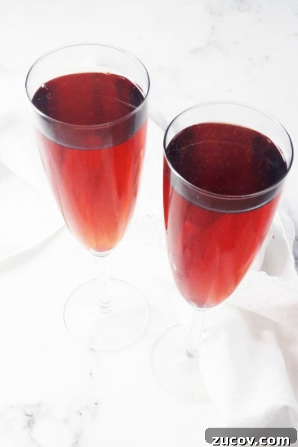 20 Must-Try Apple Cider Cocktails for Fall Gatherings 4 two apple cider cocktails - kir breton - in champagne glasses