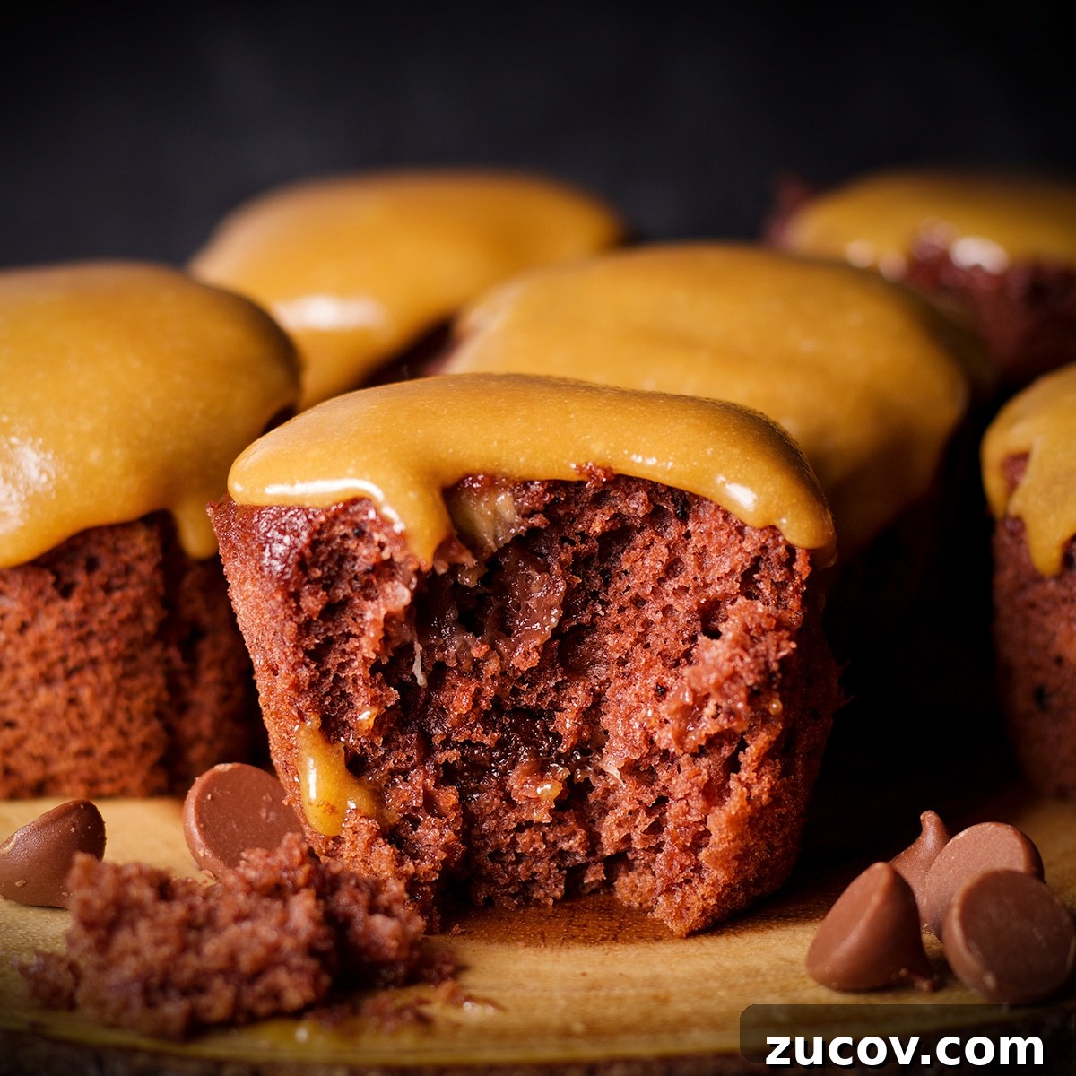 A vegan banana chocolate muffin that's been broken apart so you can see how moist and tender it is inside.